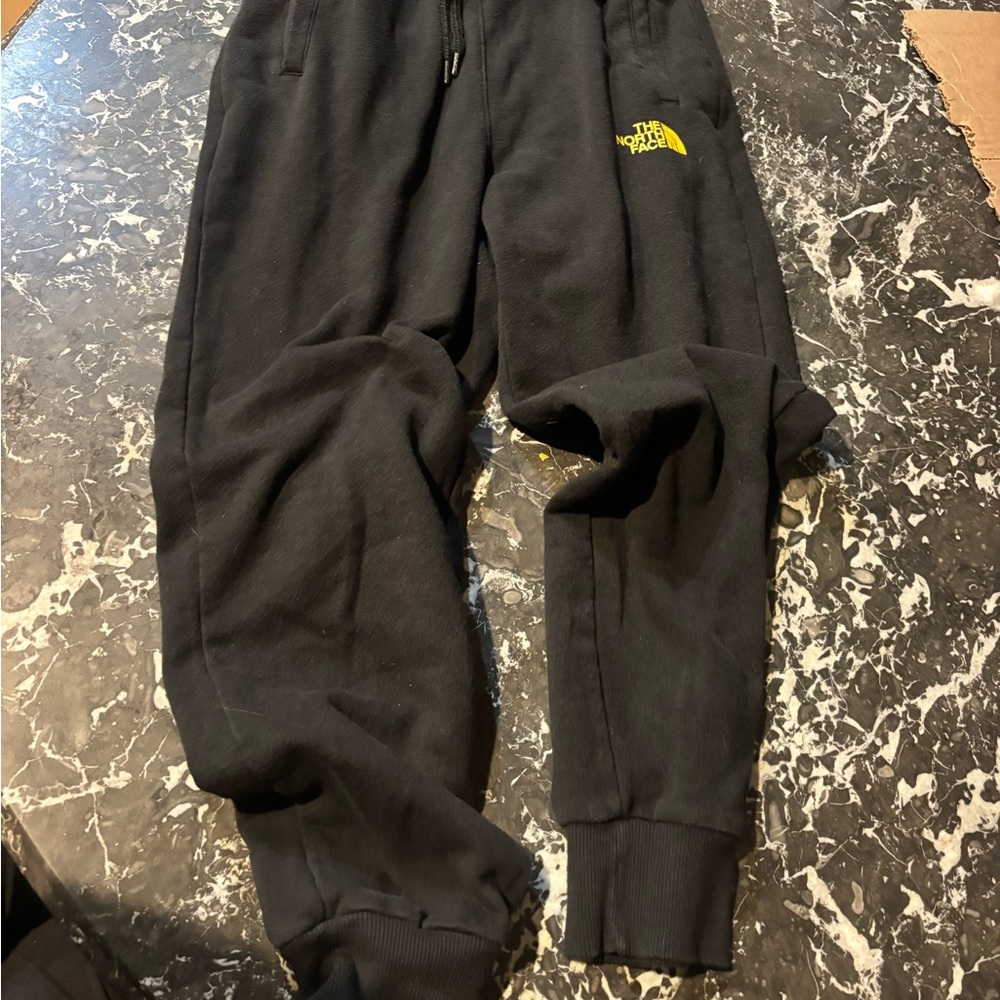 The North Face XS men’s Black Sweatpants with Yellow Logo